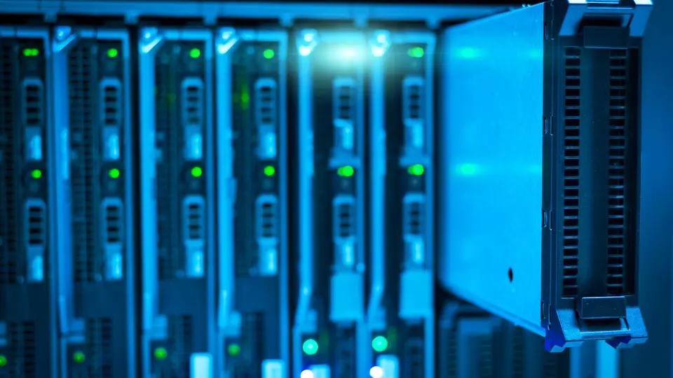 Supercomputer server room with glowing blue and green fiber optic cables