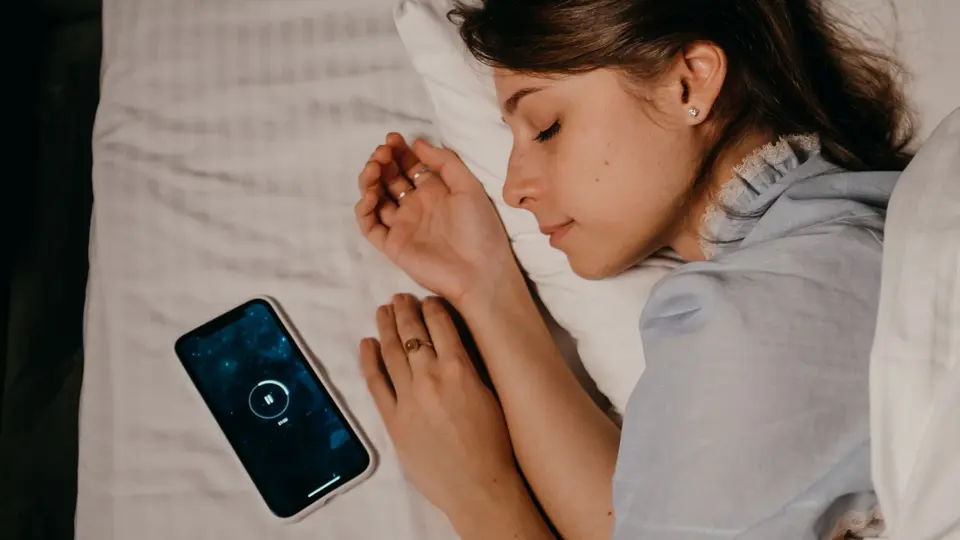 High-tech bedroom featuring red light therapy panel and sleep tracking sensor ring