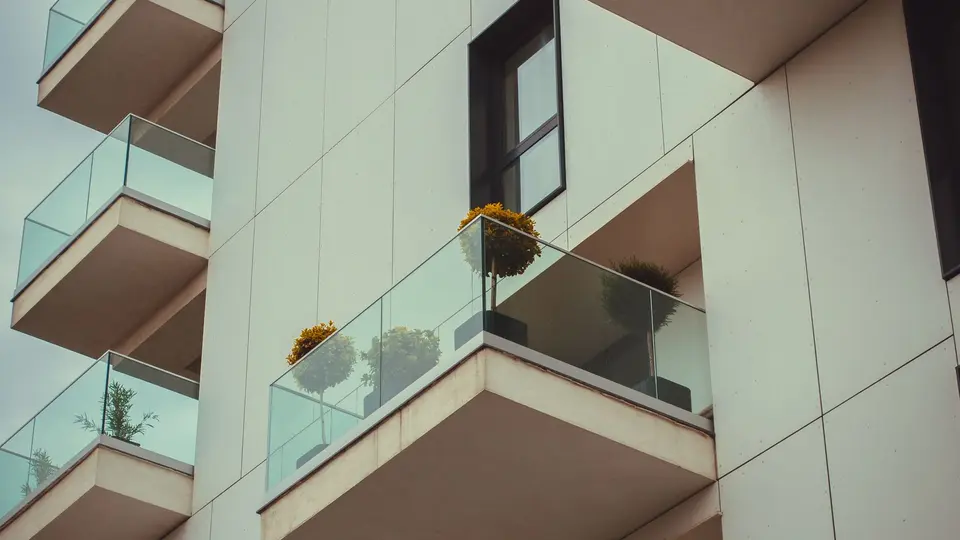 Young professional confidently walking into modern financial district at golden hour