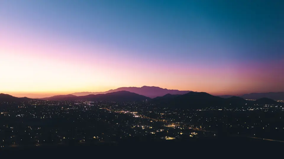 Futuristic smart city skyline at dusk with glowing neon connections